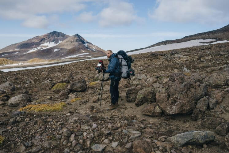 man hiking with camera bag